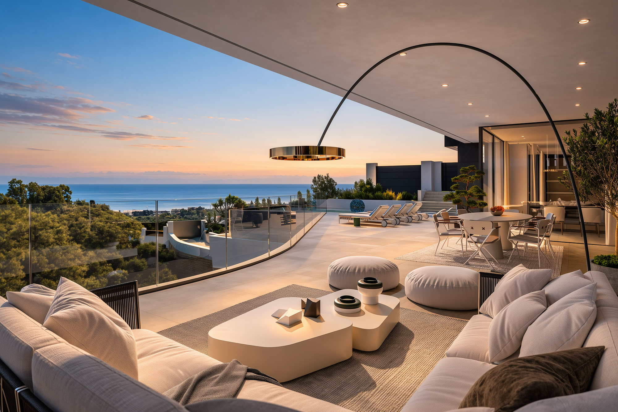 Outdoor lounge terrace at Villa Alegría with curved seating composition and open views across the Marbella mountains