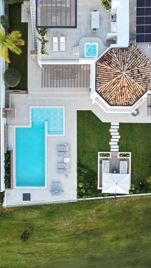 Vertical aerial view of Villa Aquila focused on the swimming pool, terraces and landscaped plot arrangement