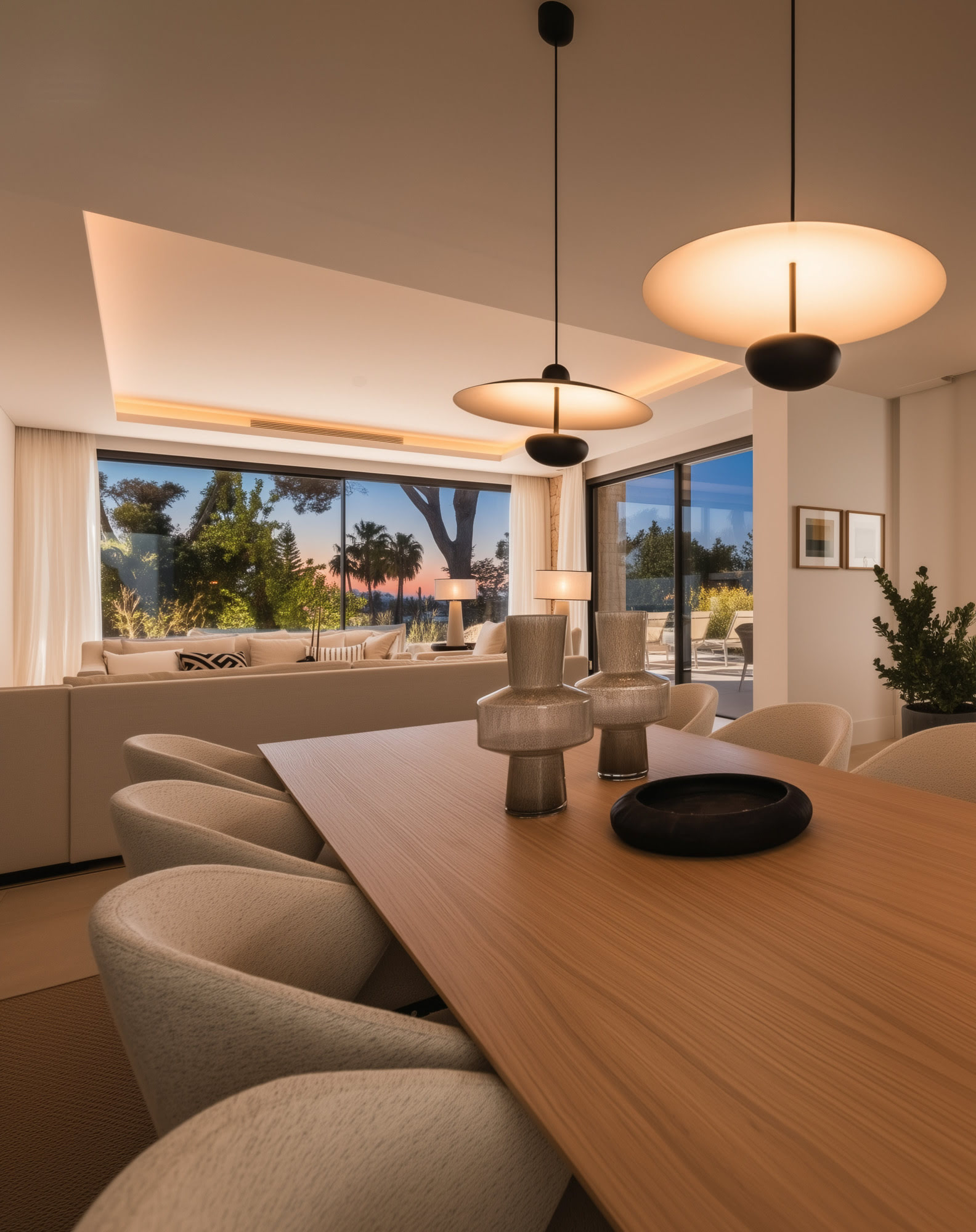 Interior view towards terrace through large sliding glass doors at night