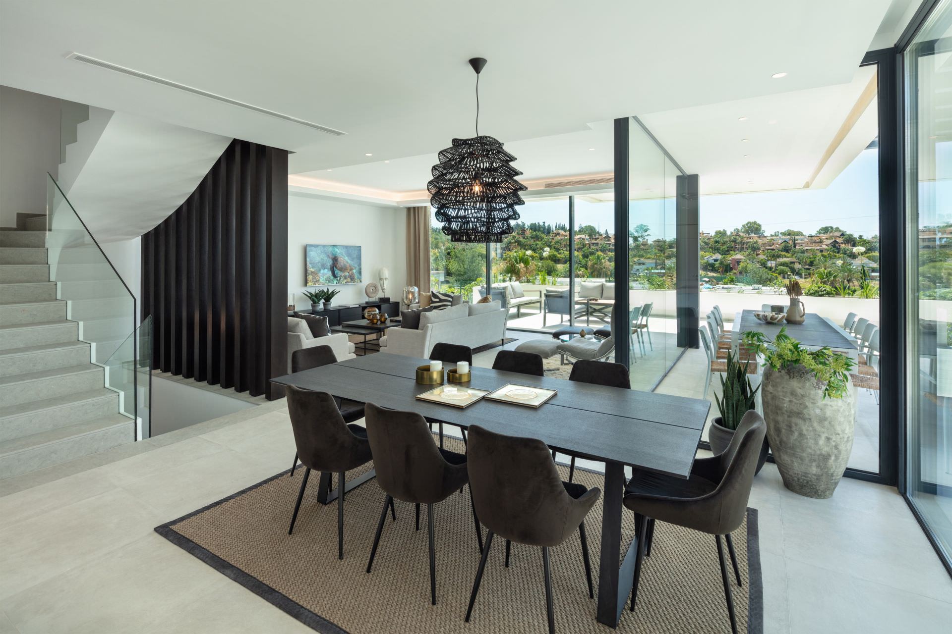 Open-plan dining and living area at BELFRY with full-height glazing and calm Mediterranean light