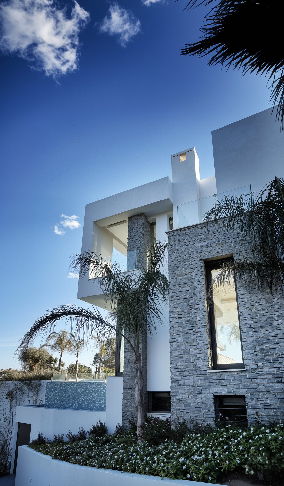 Villa Casalina exterior entrance composition with natural stone, white volumes and palm framed arrival on Marbella’s Golden Mile