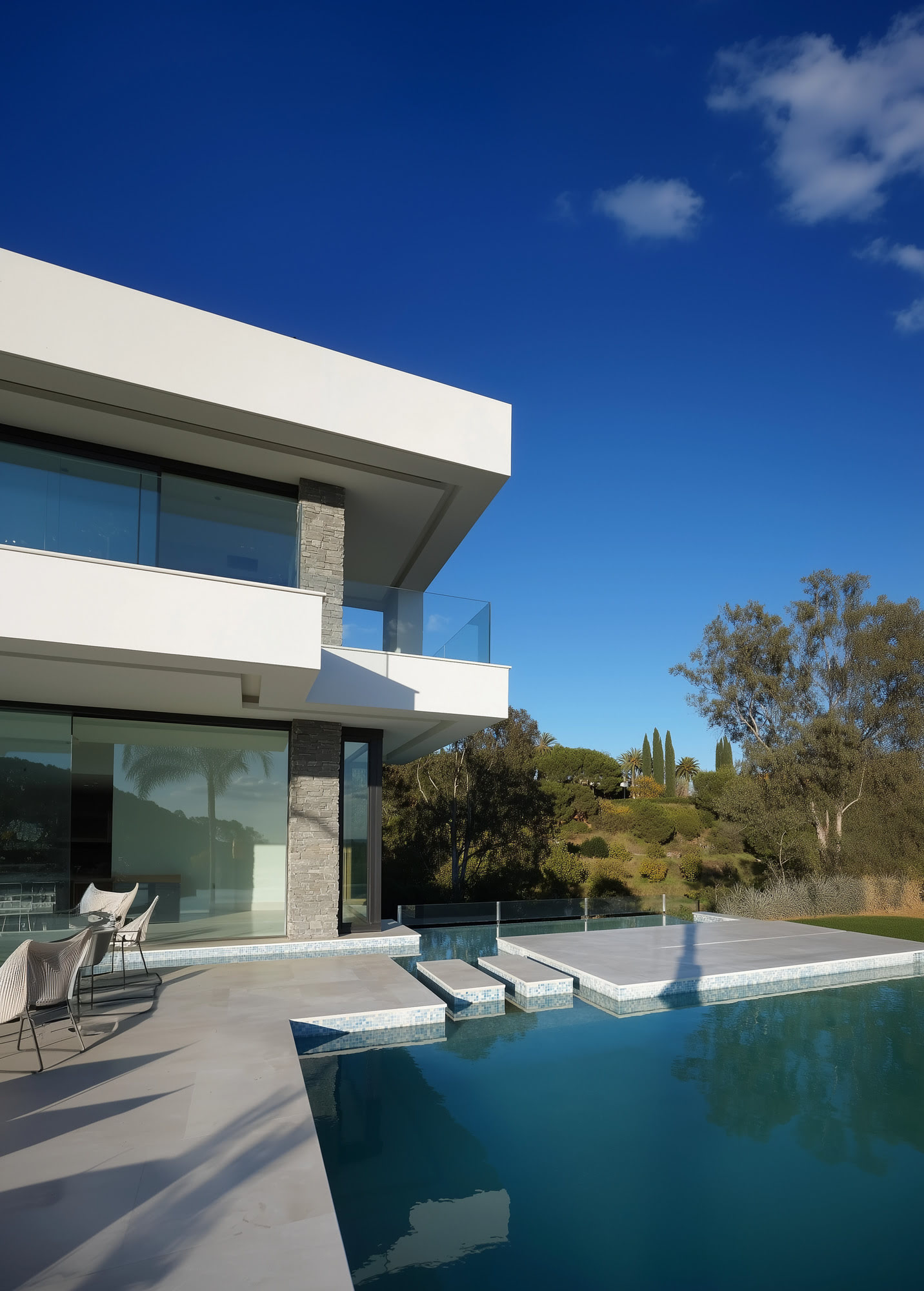 Villa Casalina pool terrace with cantilevered upper floor, shaded outdoor living and clear blue sky