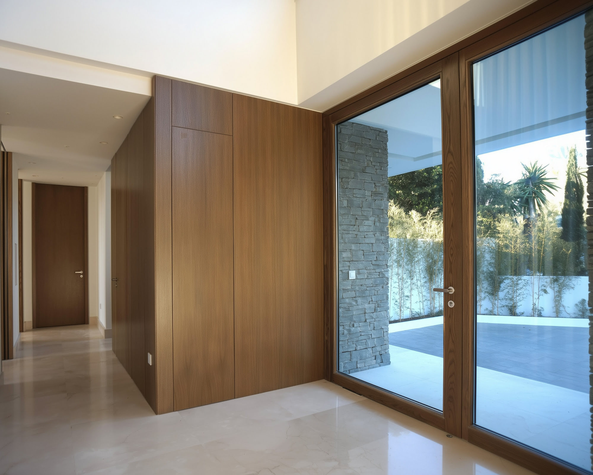 Villa Casalina transition space with full height timber cladding and framed view to the pool terrace