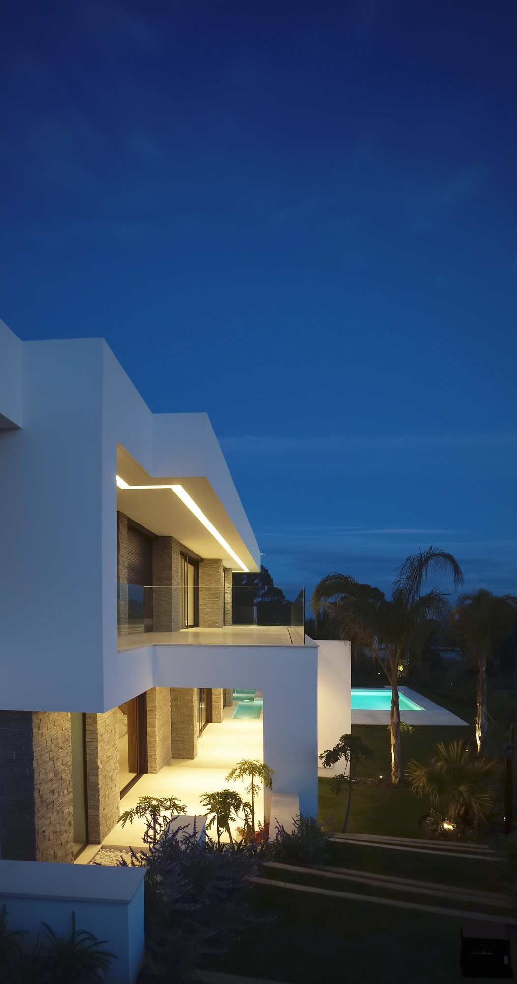 Villa Casalina evening exterior with warm architectural lighting and serene Golden Mile atmosphere