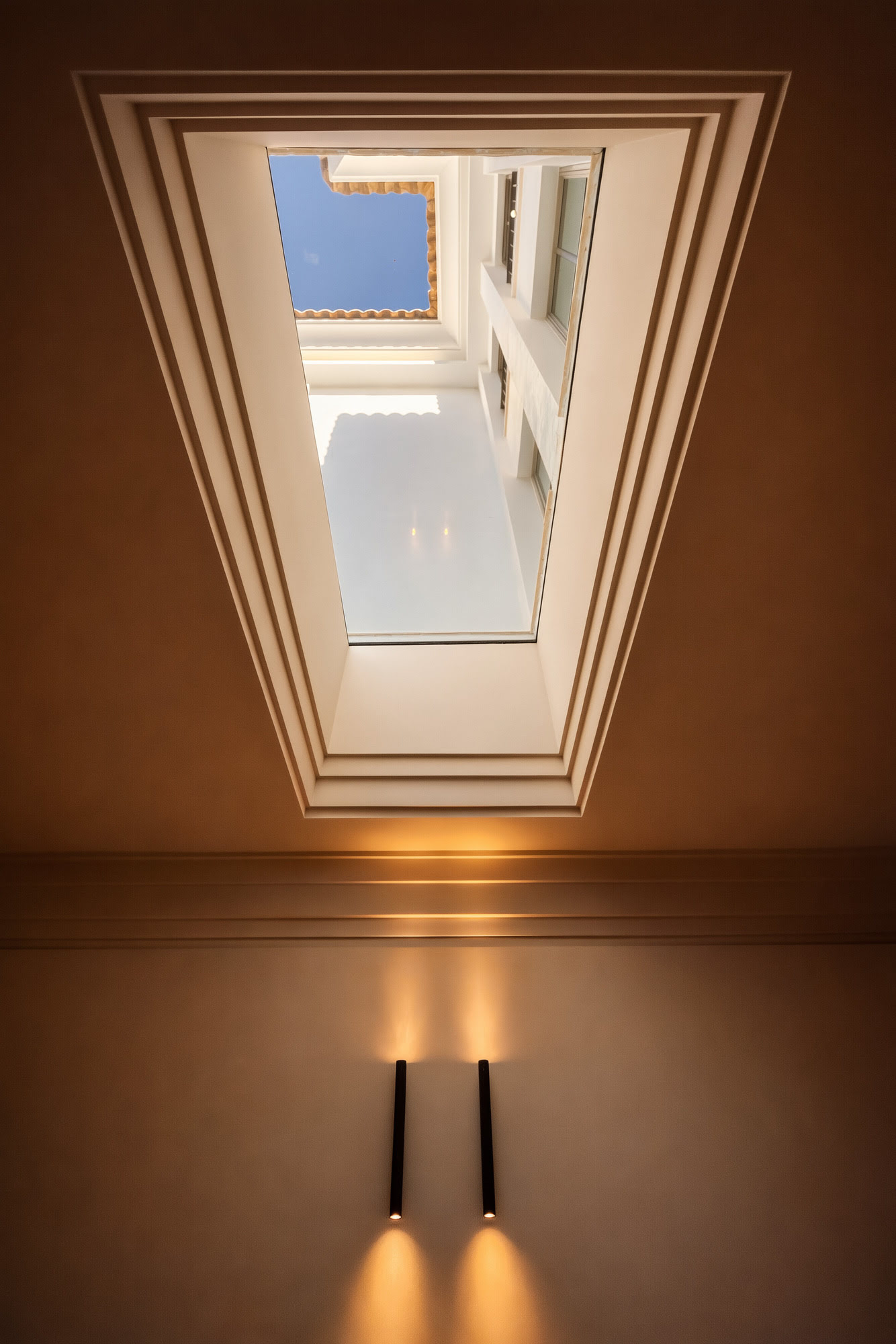 Vertical skylight detail at Villa Diva bringing daylight into a warm and composed interior sequence