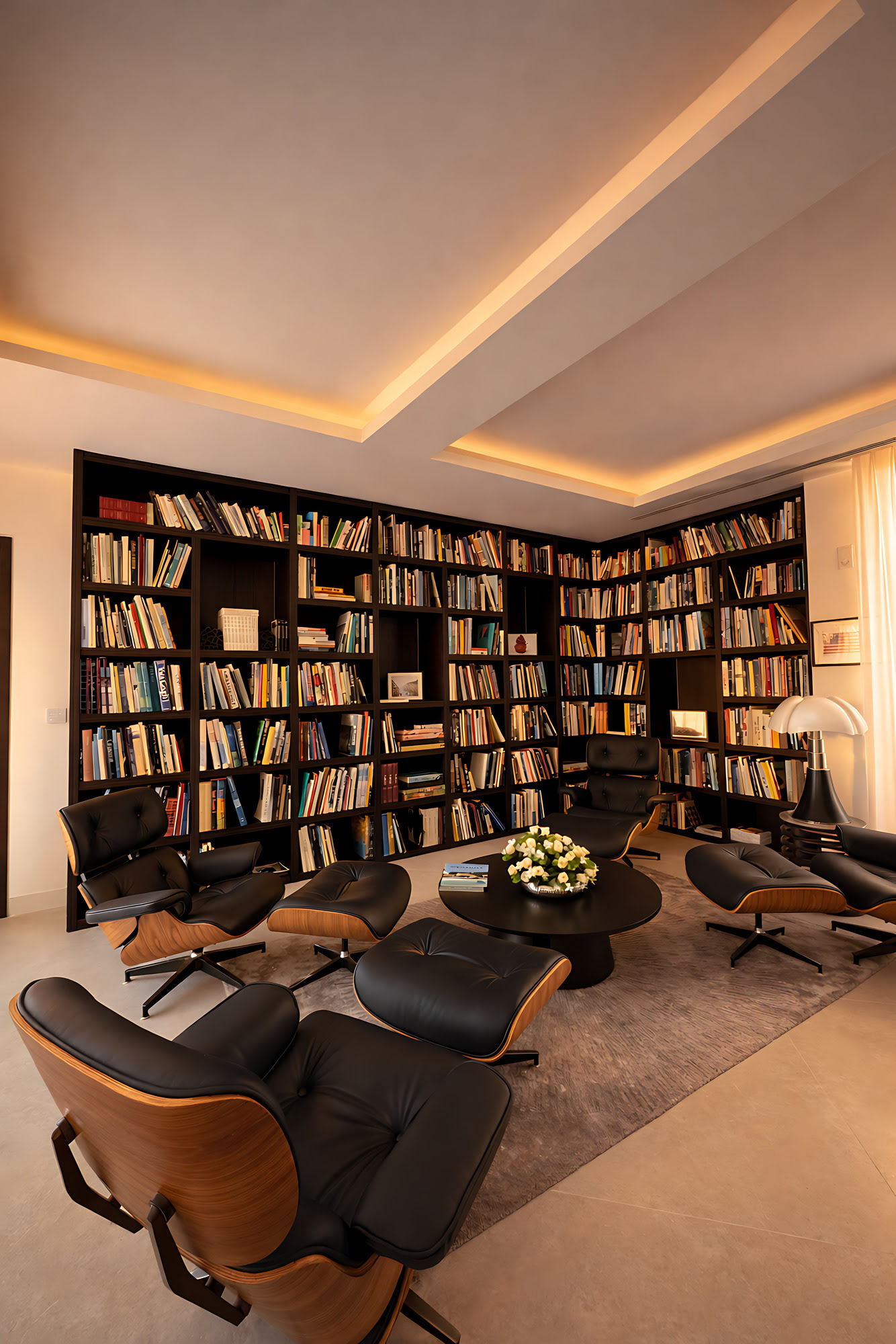Private library and reading lounge at Hillview Estate with bespoke shelving, warm ambient light and intimate seating