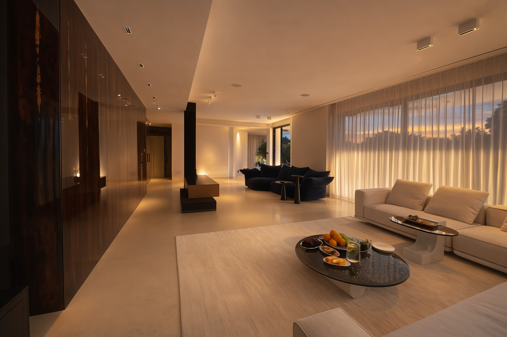 Interior corridor at Villa Inés with long perspective, polished flooring and sculptural pool table