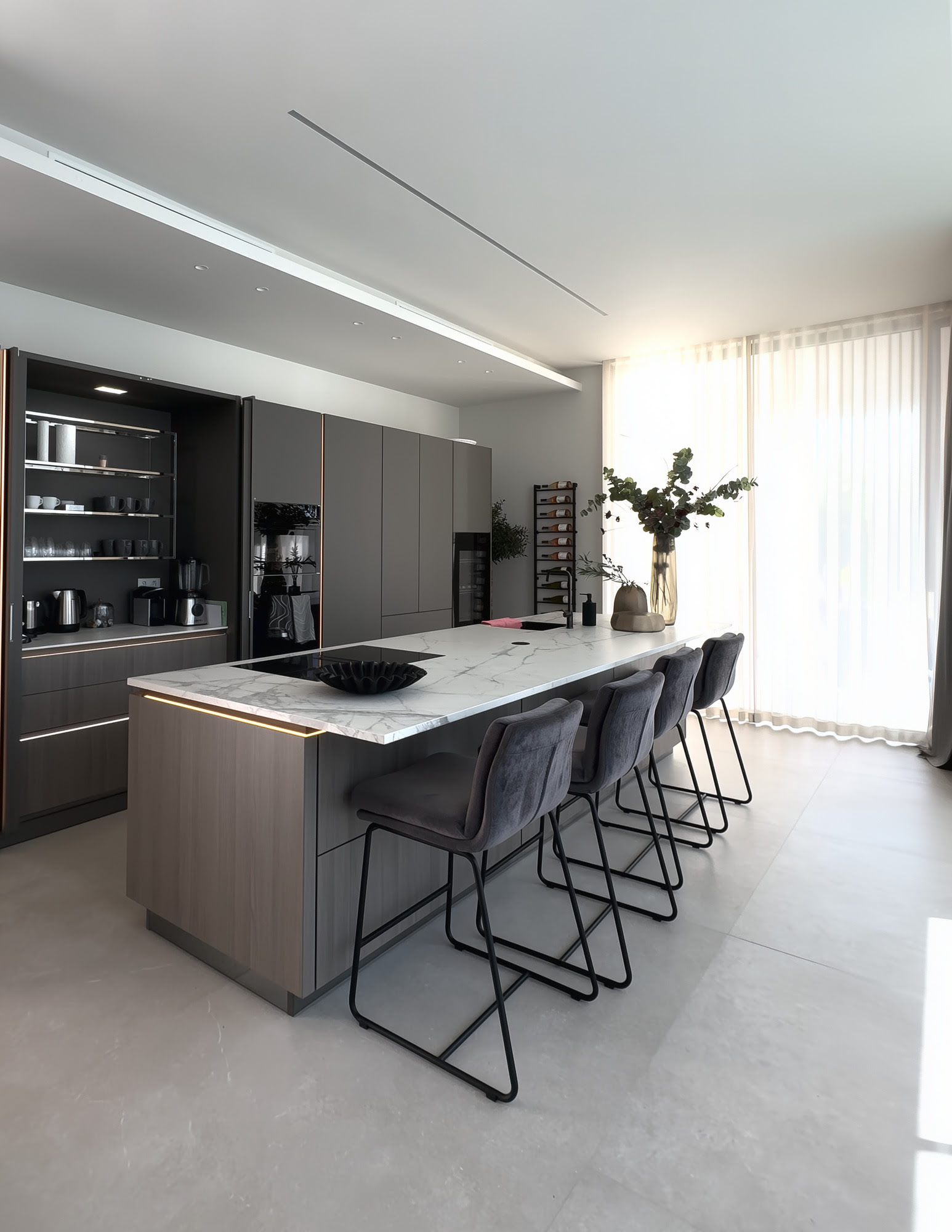 Minimal contemporary kitchen at M94 with island, integrated cabinetry and soft natural daylight