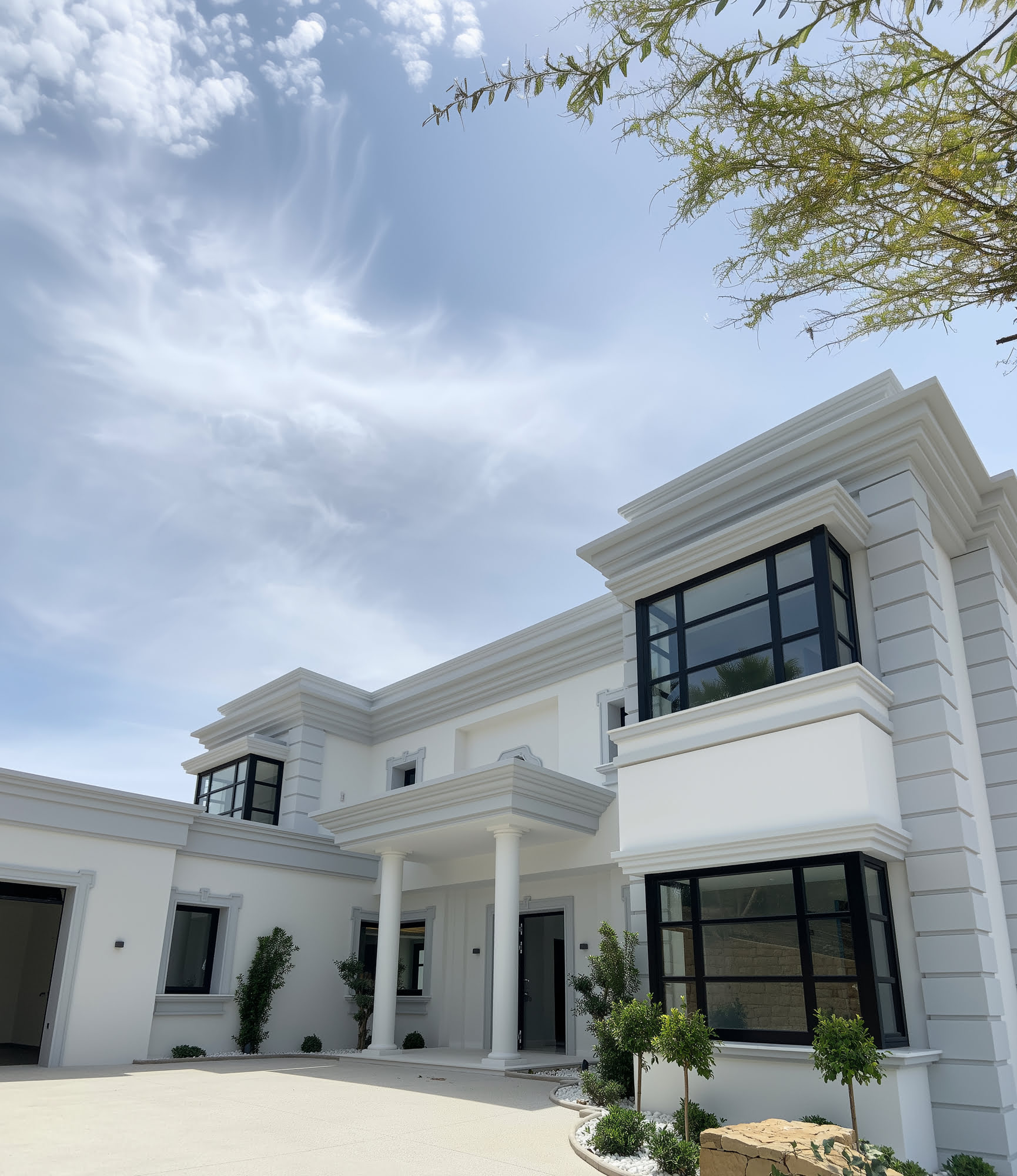 Arrival view of Villa Mariselena showing the classical front façade, columns and balanced composition in La Zagaleta