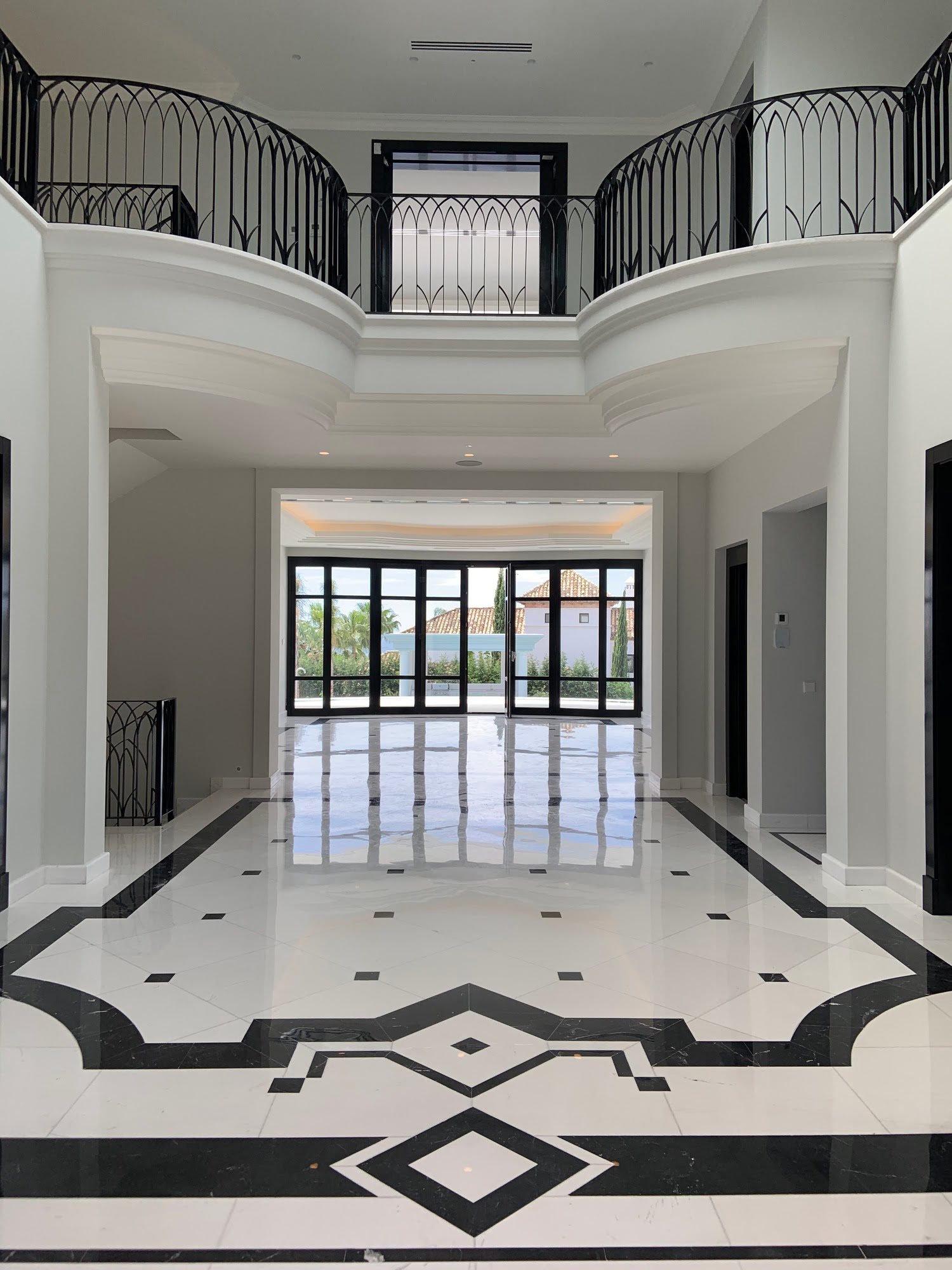 Entrance hall of Villa Mariselena with black and white marble flooring and double-height classical gallery