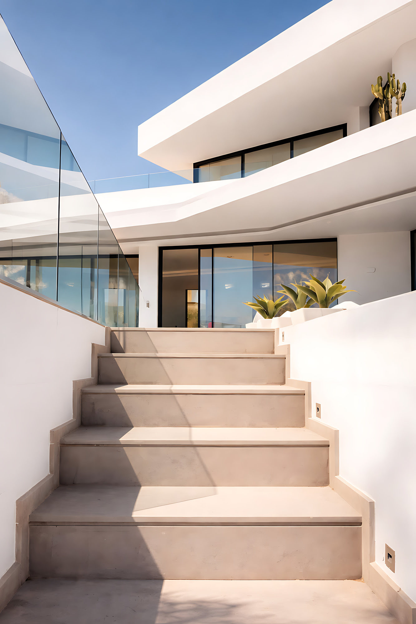 Architectural stair approach at Villa Origami leading between white walls and glass balustrades