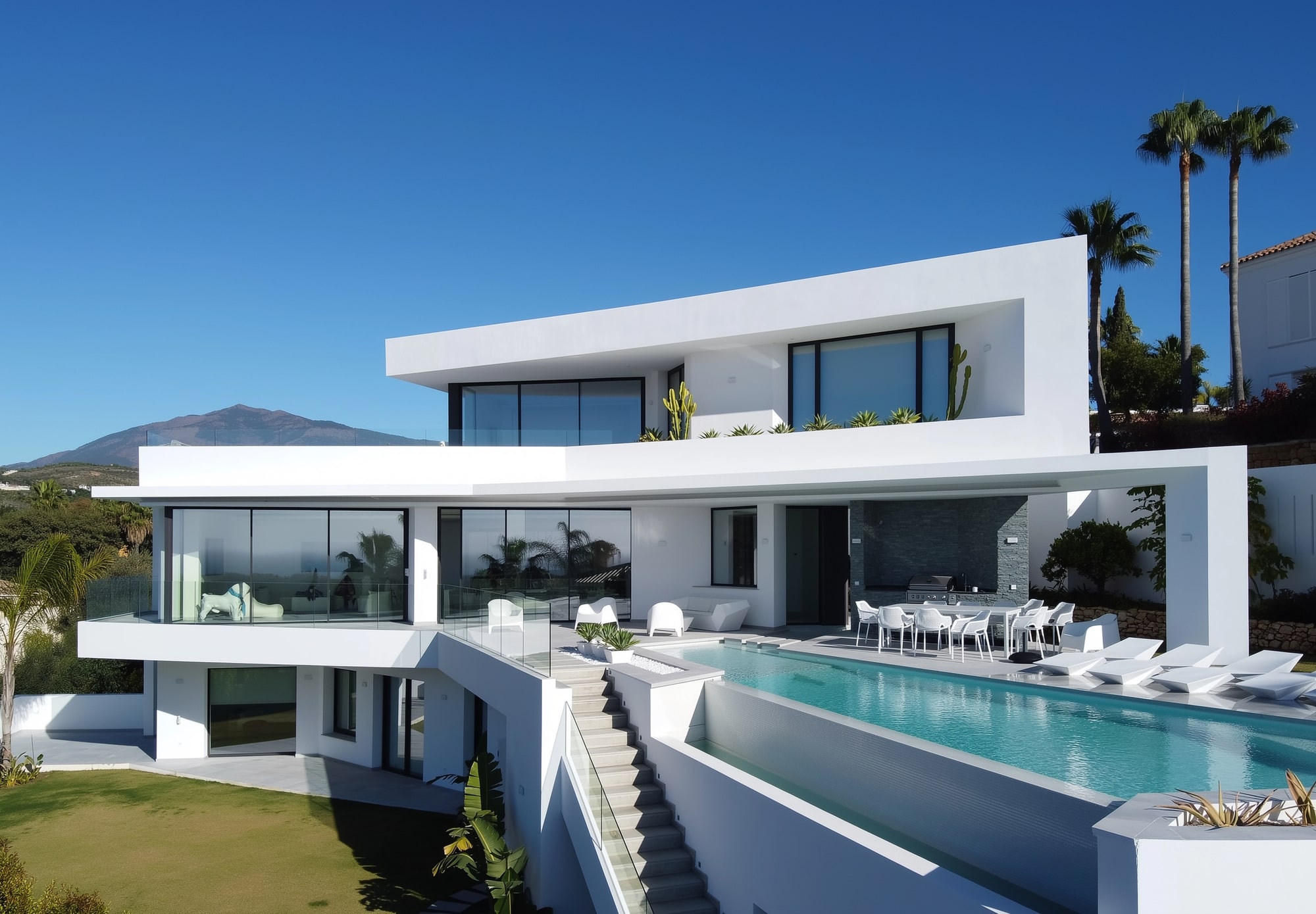 Main exterior façade of Villa Origami with infinity-edge pool, layered terraces and contemporary white architecture
