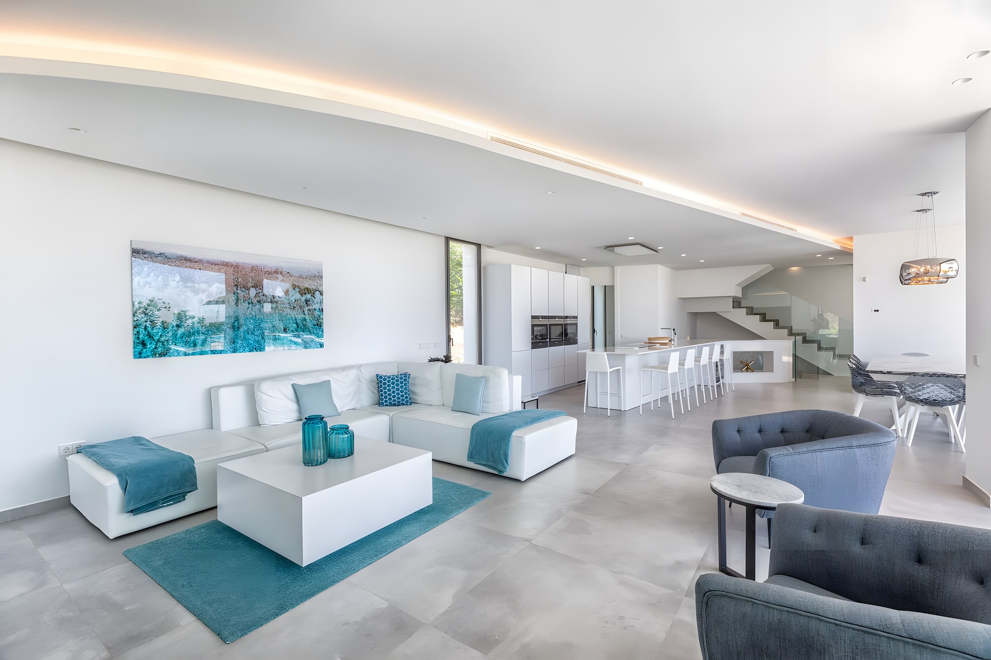Bright lounge interior at Villa Origami with soft neutral furnishings and a framed landscape outlook