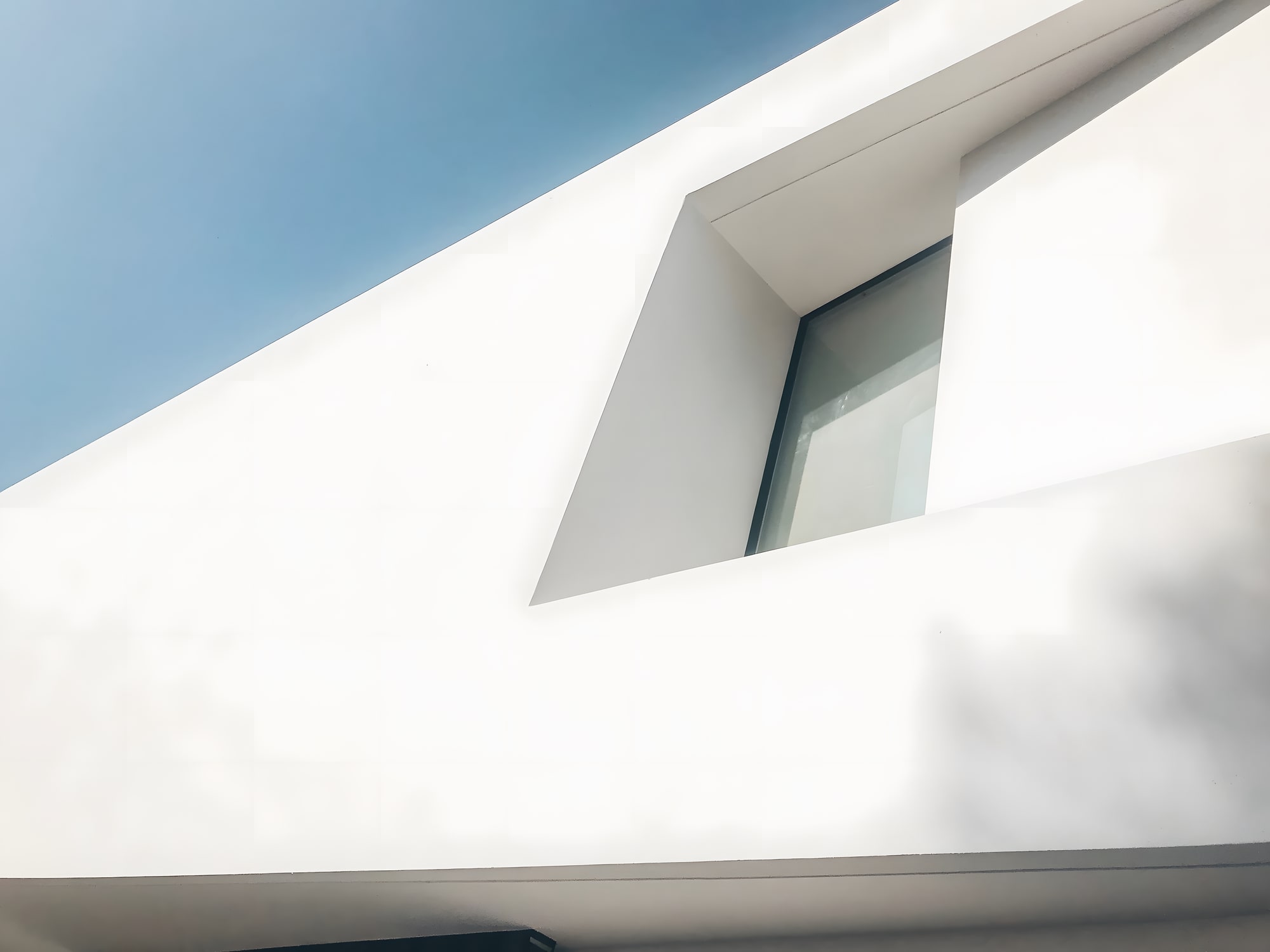 Close-up of Villa Origami sculptural envelope with deep reveals, sharp folds and soft natural light