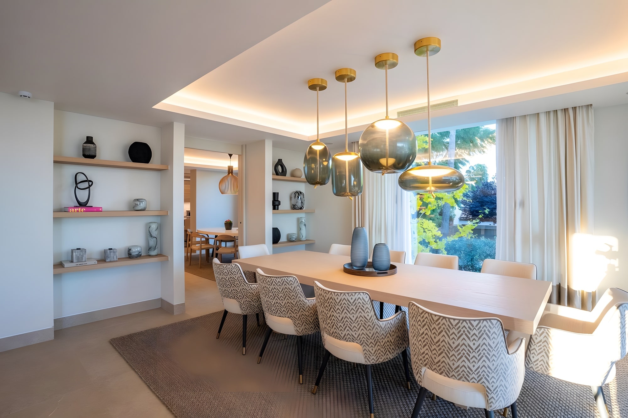 Open-plan dining and kitchen area with bespoke lighting and contemporary Mediterranean styling