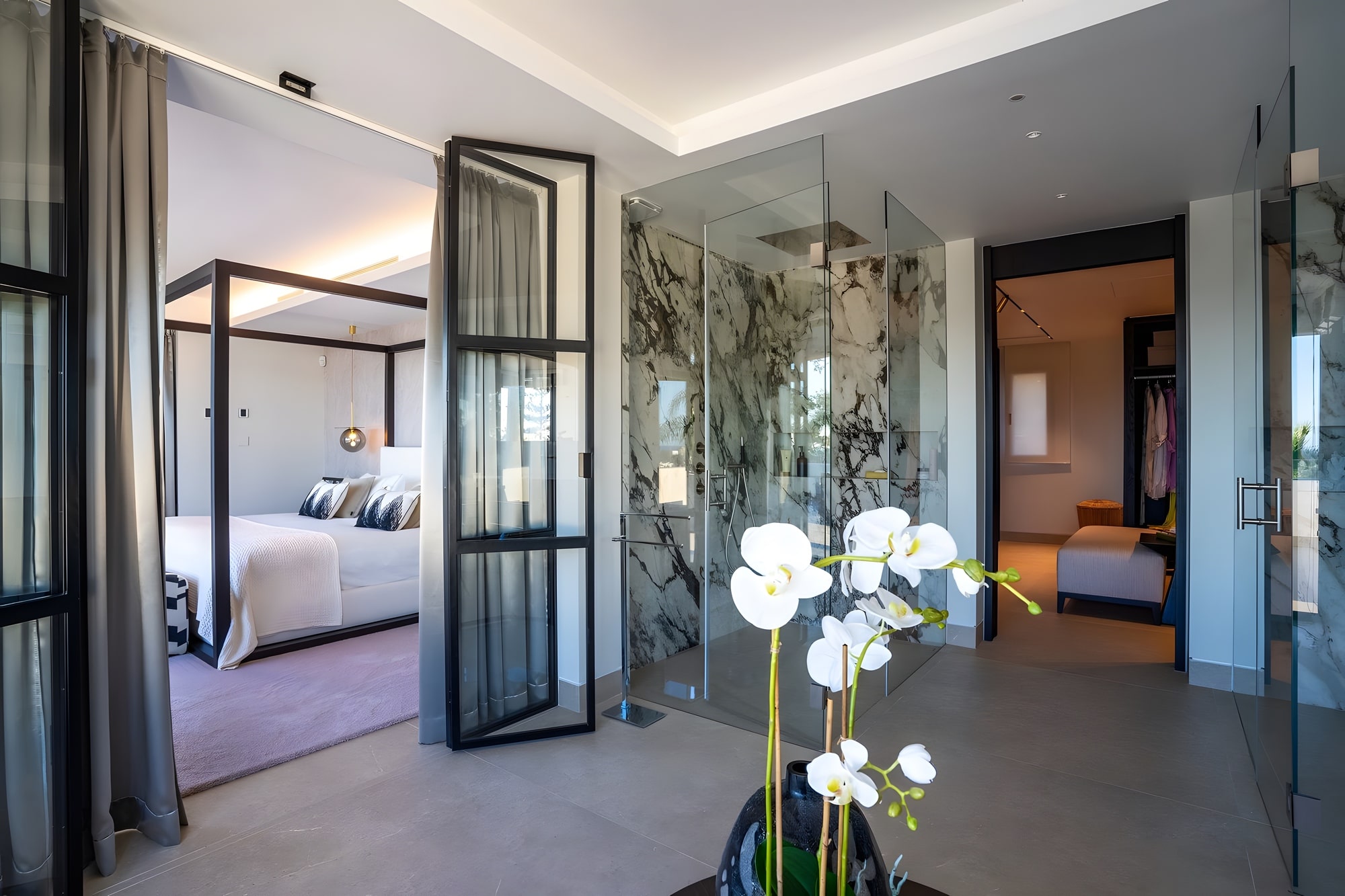 Glass-lined dressing and circulation space connected to the bedroom suite
