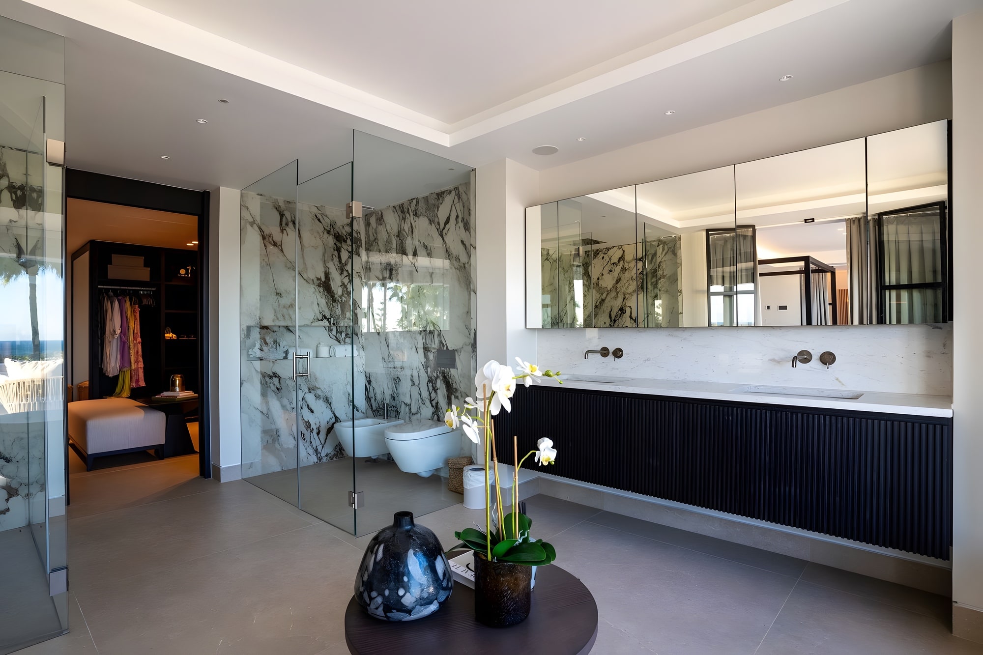 Bathroom and vanity area with stone finishes, bespoke cabinetry and integrated mirrors