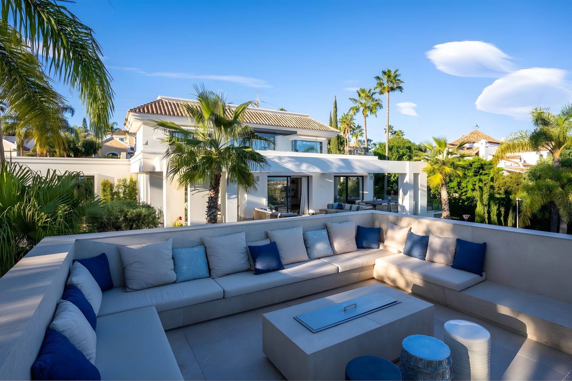 Elevated outdoor lounge terrace with custom seating and open views at Casa de las Palmeras