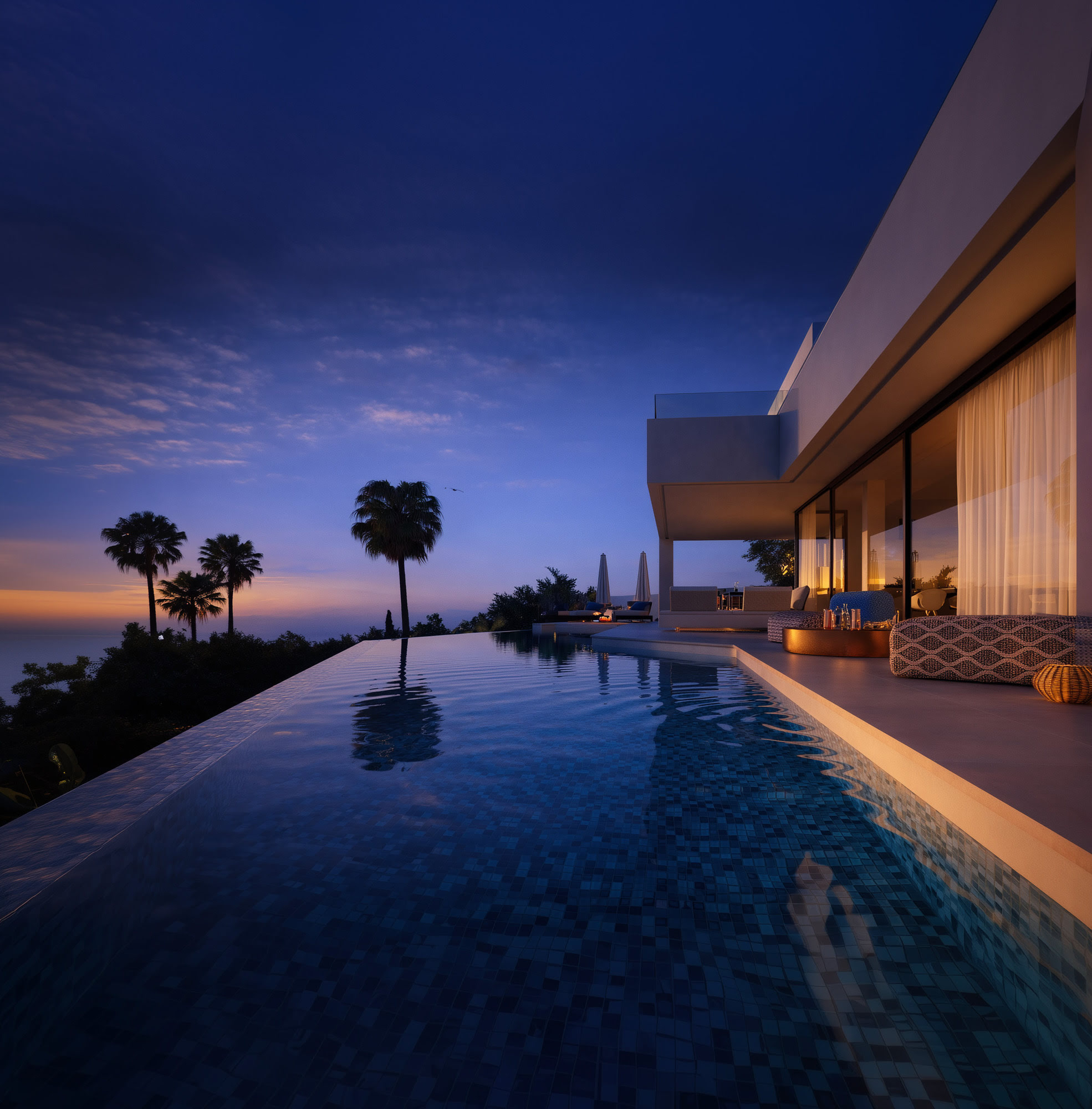 Twilight infinity pool perspective at Villa Riviera with long linear water surface and warm architectural glow