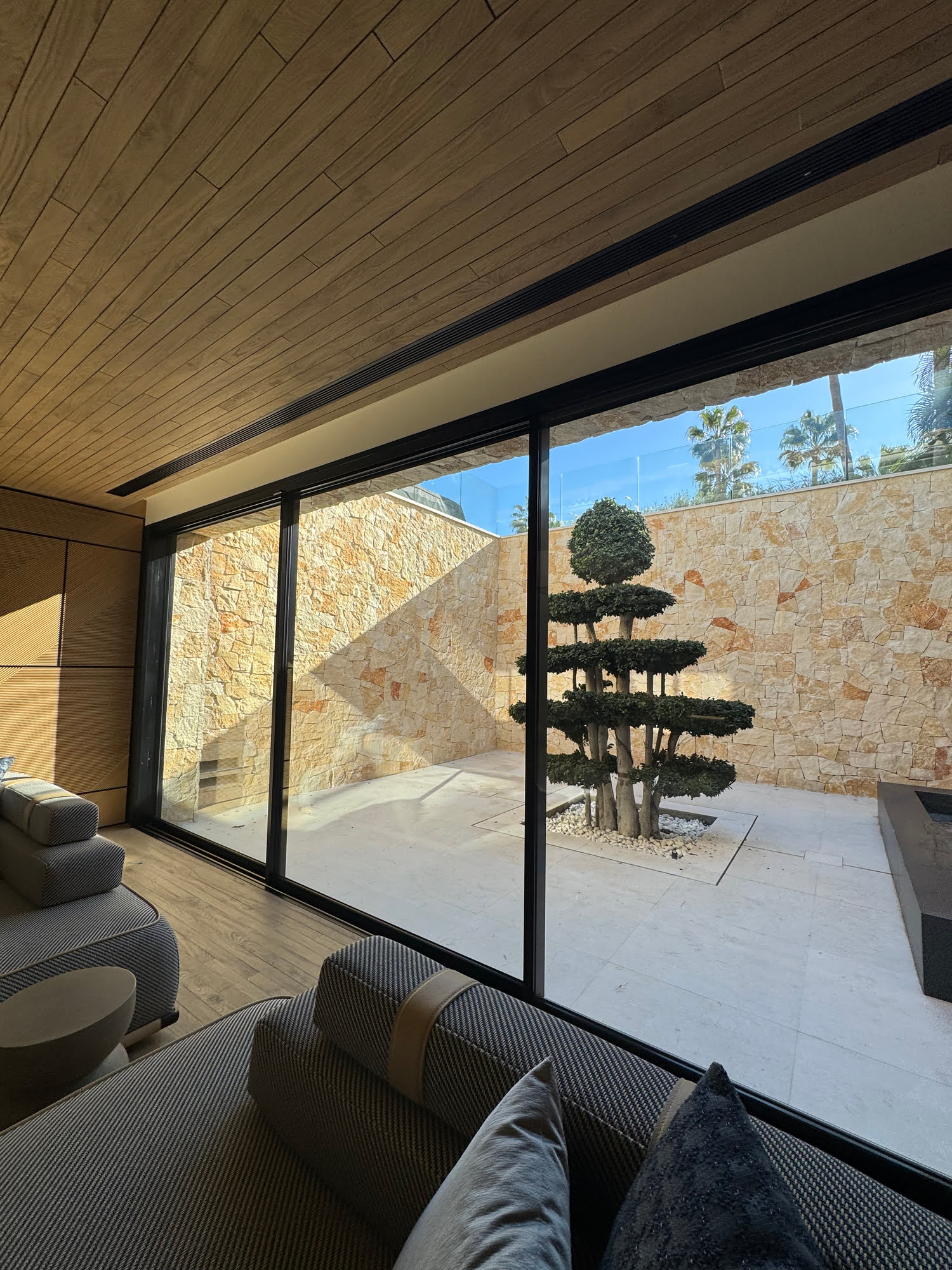 Private lounge or library with large picture window and warm timber ceiling at Villa Shangri-La