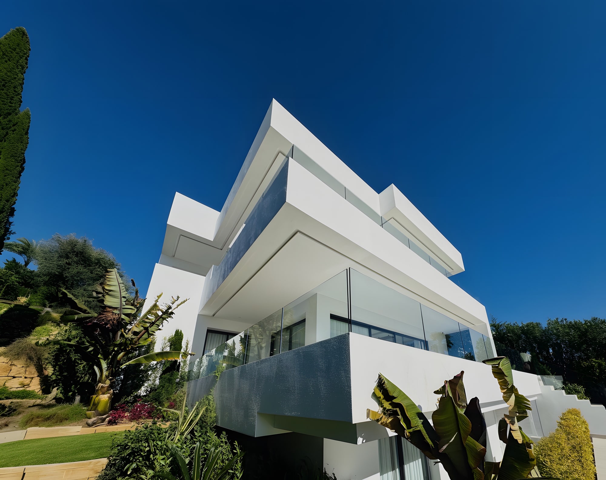 Low angle exterior view emphasising the cantilevered geometry and sculptural lines of the villa