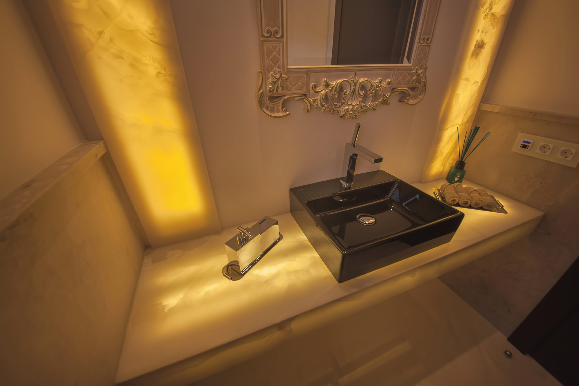 Warm illuminated sink detail in a bespoke bathroom at Villa Tanya