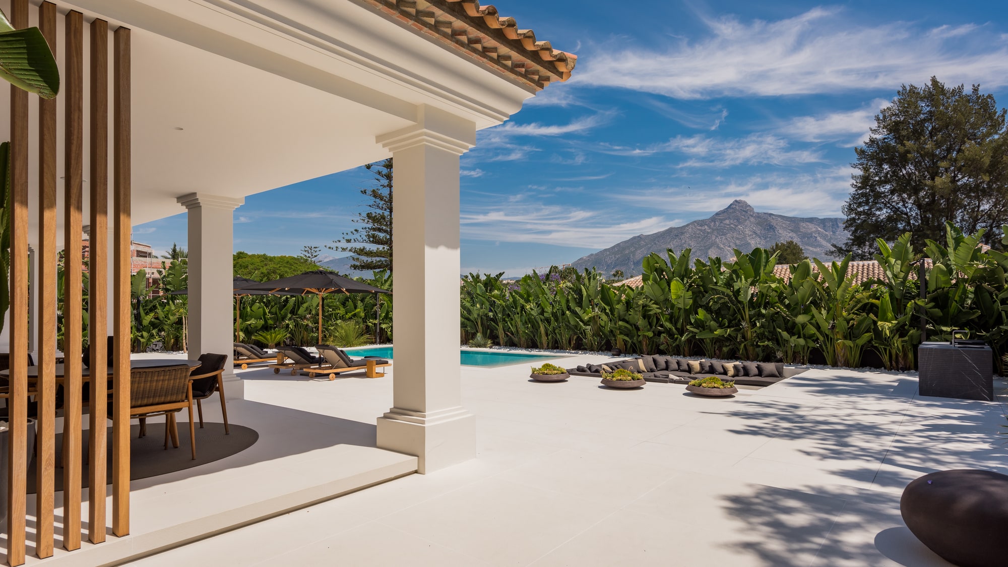 Covered outdoor terrace at Villa Zarina overlooking the pool, designed for shaded living and refined open-air relaxation