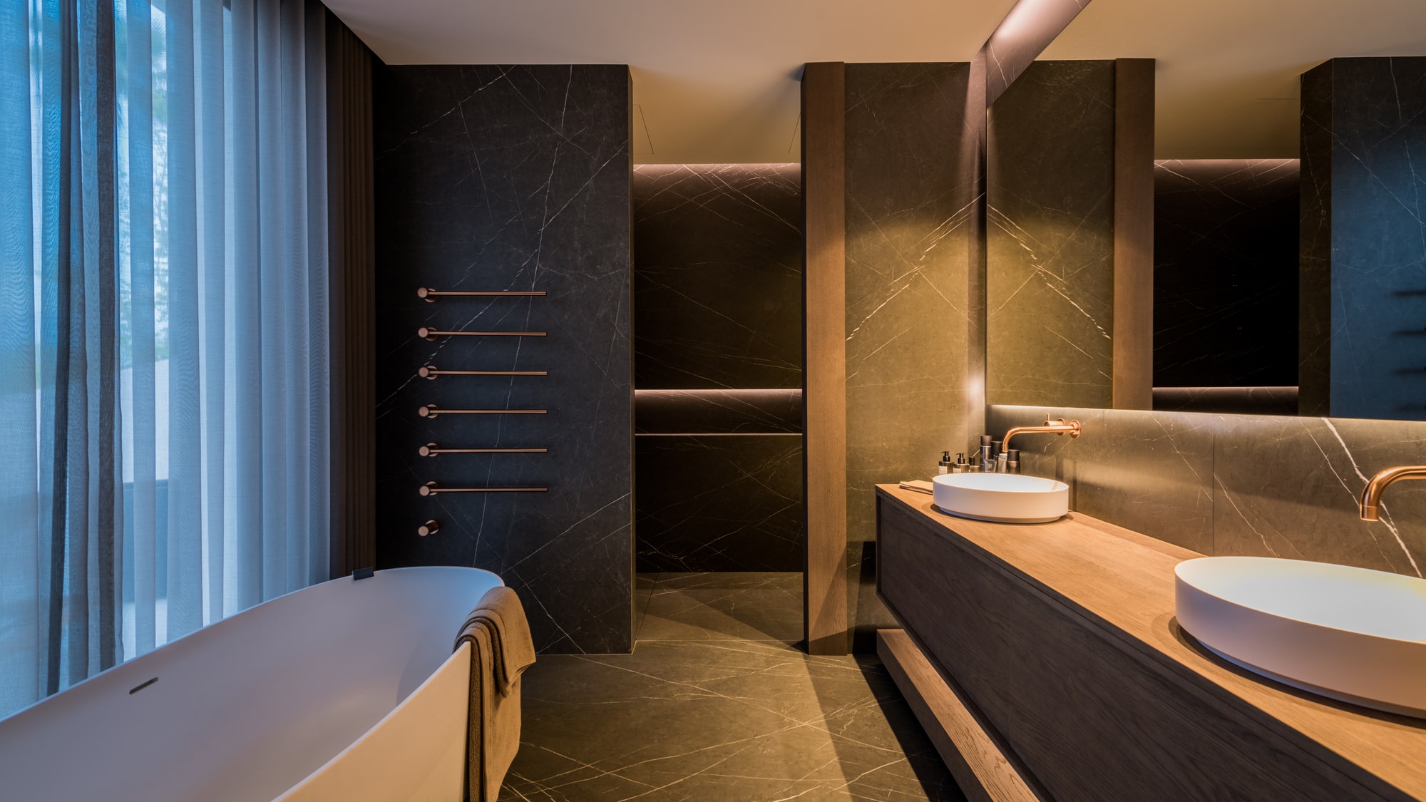Spa-style bathroom at Villa Zarina with bathtub, layered lighting and calm natural textures